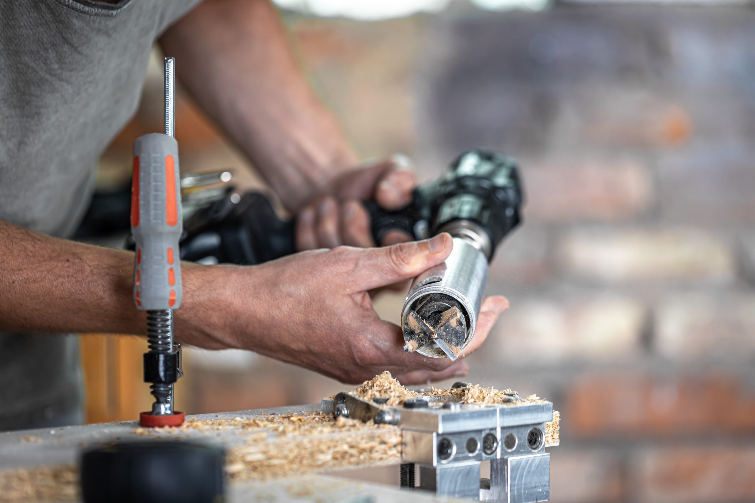 close up a carpenter working with wood and building tools in house.