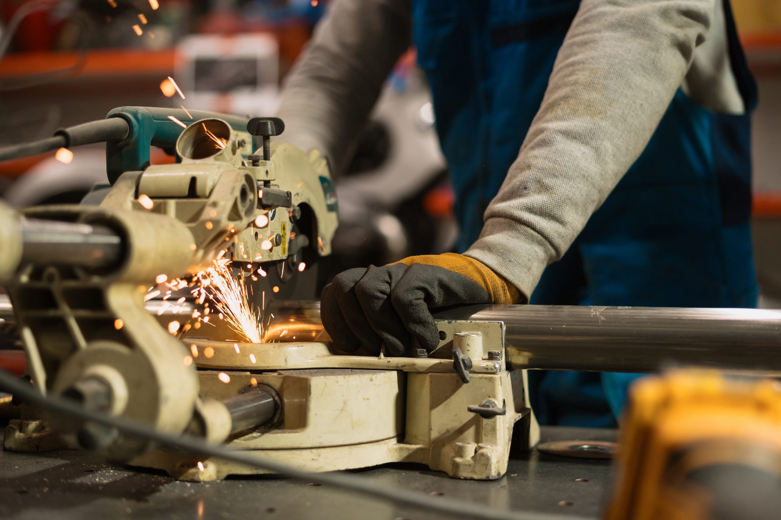 Machine Tools worker working with a circular grinder on a metal with sparks